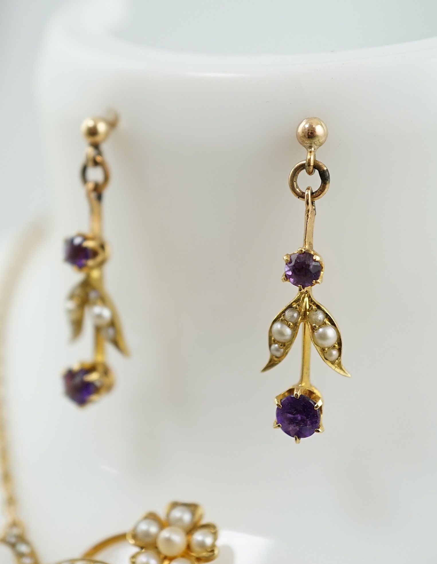 An Edwardian 15ct gold, seed pearl and amethyst set drop necklace and a pair of matching unmarked earrings